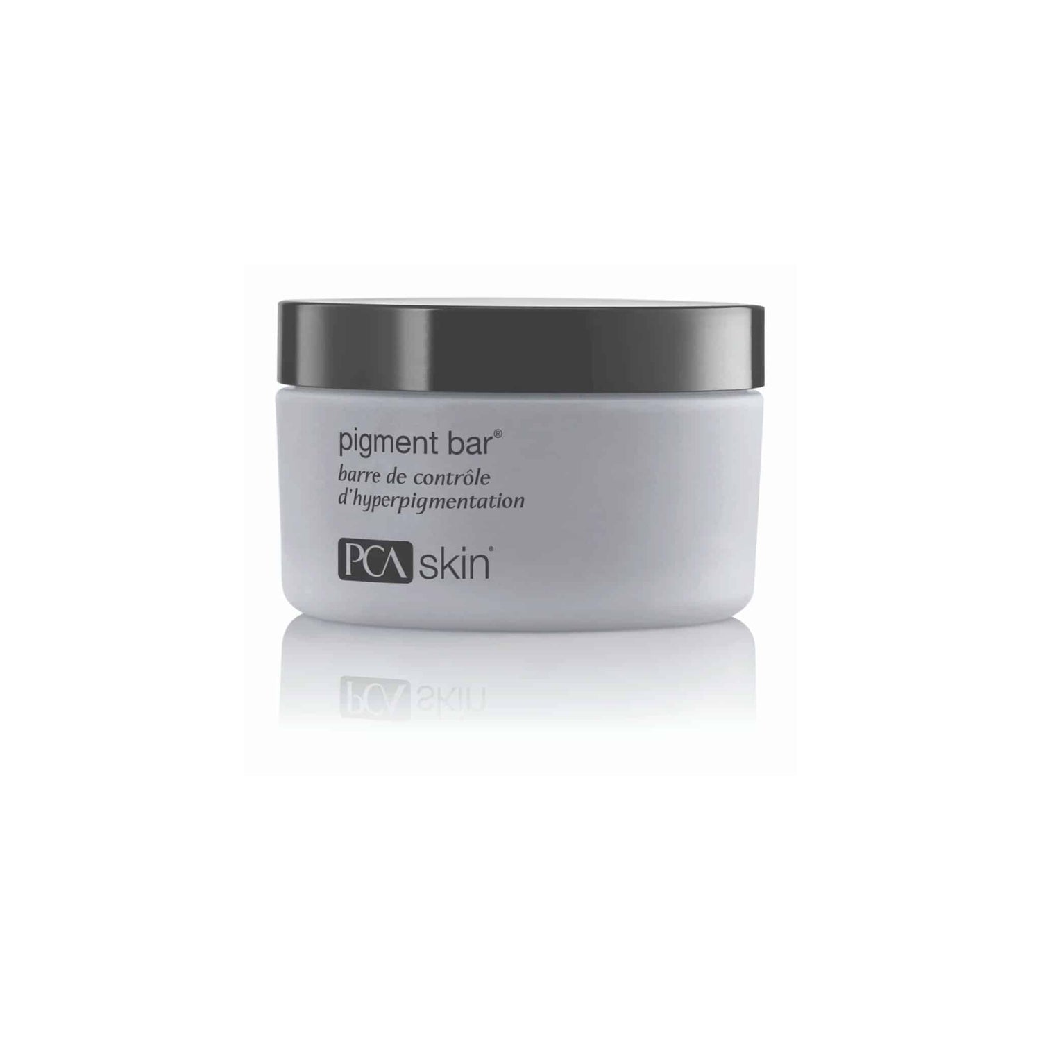 A white tub with a black lid, labeled "Pigment Bar" and "PCA Skin," indicates it is a cleansing bar for managing hyperpigmentation and achieving an even skin tone. The text on the tub is written in both English and French.