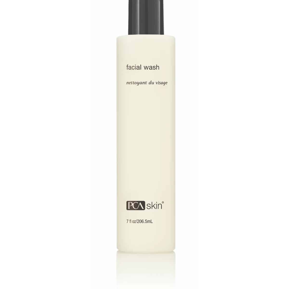 A bottle of Facial Wash, labeled in both English and French ("nettoyant du visage"), hydrates and exfoliates normal and sensitive skin. The off-white bottle with a black cap contains 7 fl oz (206.5 mL) of product, perfect for your skincare routine.
