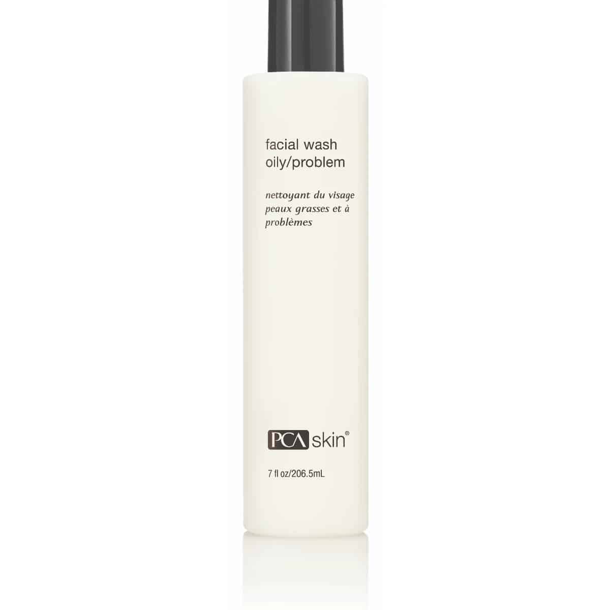 A white cylindrical bottle with a black cap labeled "Facial Wash Oily/Problem" and "PCA skin" on the front, ideal for pimple-prone skin. The text is in both English and French. The bottle capacity is indicated as 7 fl oz/206.5 mL.