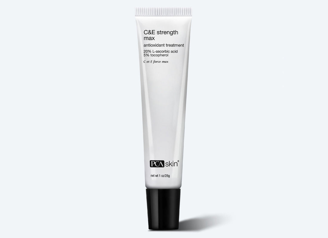A white tube of C&E Strength Max antioxidant treatment with 20% pure vitamin C and 5% tocopherol, 1.2 oz. The tube has a black cap and text detailing the product and ingredients, designed to tackle fine lines and wrinkles. It is placed against a plain, light background.