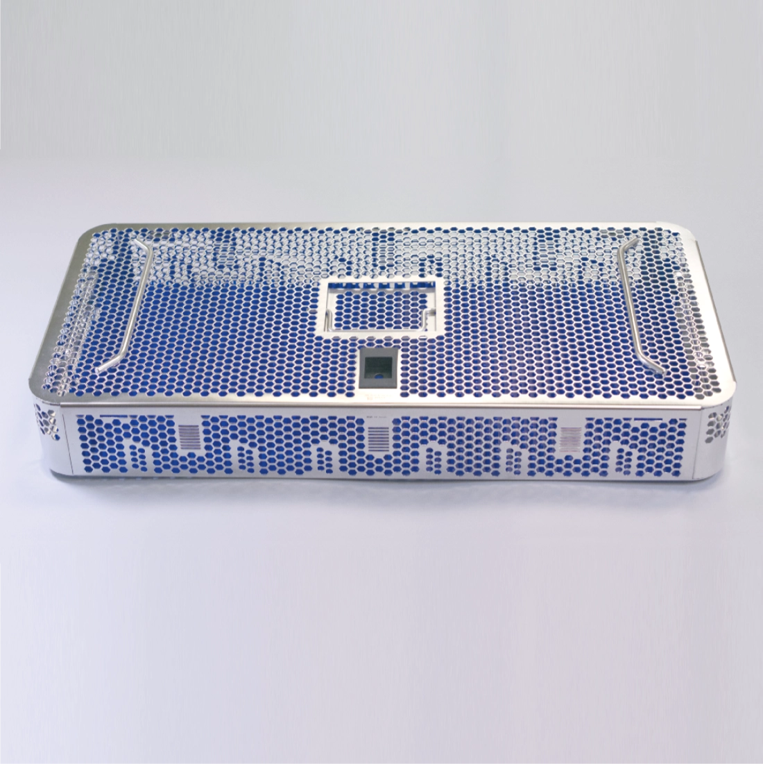 A sleek, modern Sterilization Tray Single Level Stainless Steel w/ Locking Lid & Silicone Mat, 20.4″ x 9.5″ x 2.75″ with a perforated design featuring blue circular holes is set against a light grey background. The tray has a central rectangular cutout, ideal for the transport of instruments and designed to sterilize instruments efficiently.