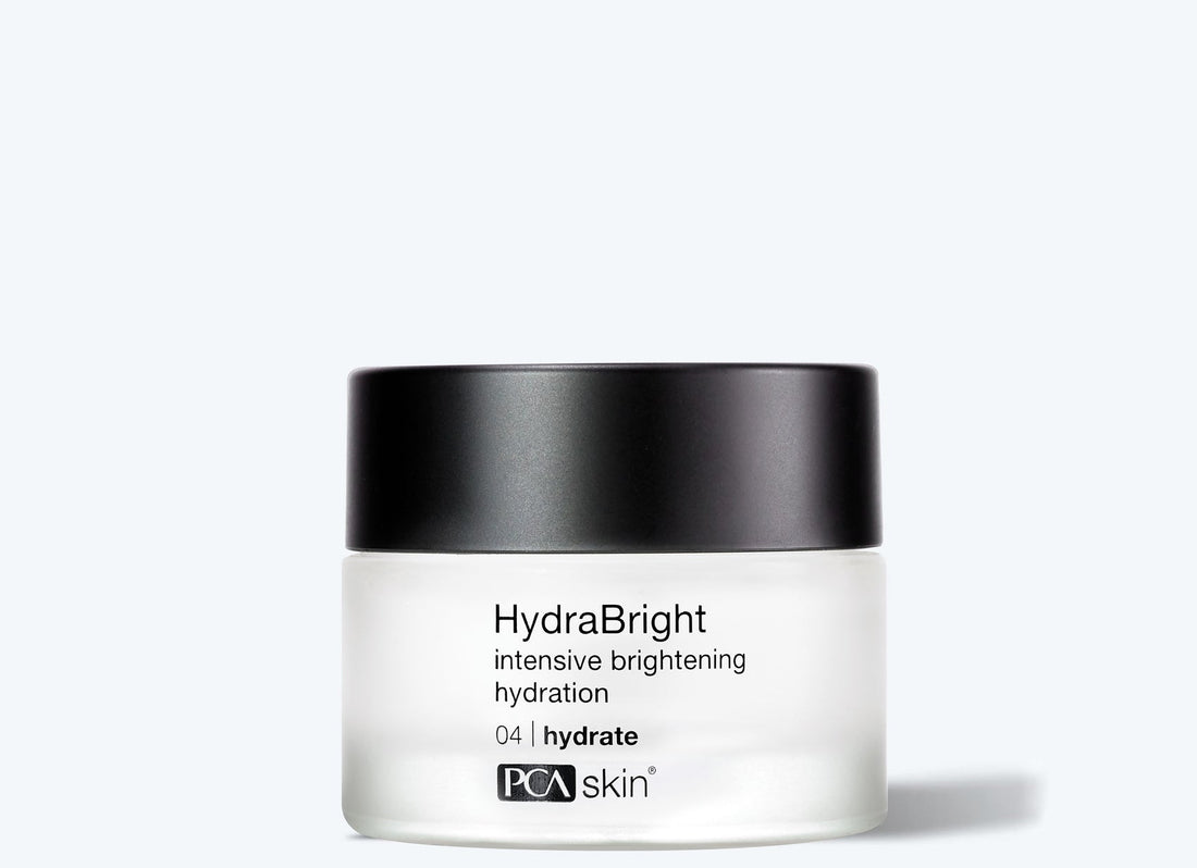 A small frosted jar of HydraBright 50 ml moisturizer with a black lid is shown against a plain light background, ideal for dry skin.