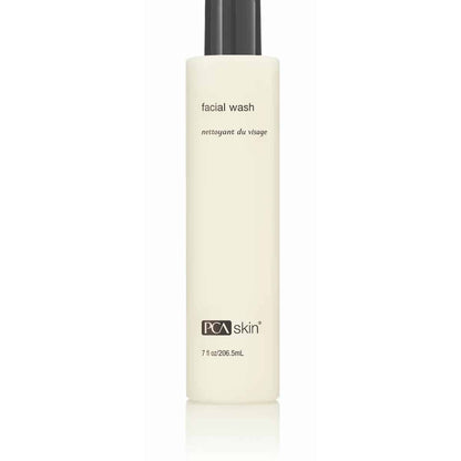 A bottle of Facial Wash, labeled in both English and French (&quot;nettoyant du visage&quot;), hydrates and exfoliates normal and sensitive skin. The off-white bottle with a black cap contains 7 fl oz (206.5 mL) of product, perfect for your skincare routine.