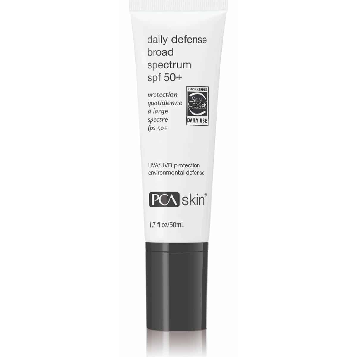 A white tube labeled &quot;Daily Defense SPF 50+&quot; with &quot;UVA/UVB protection&quot; and &quot;environmental defense ingredients&quot; by PCA Skin. It has a black cap and text in both English and French. The tube contains 1.7 fl oz or 50 mL of sunscreen.