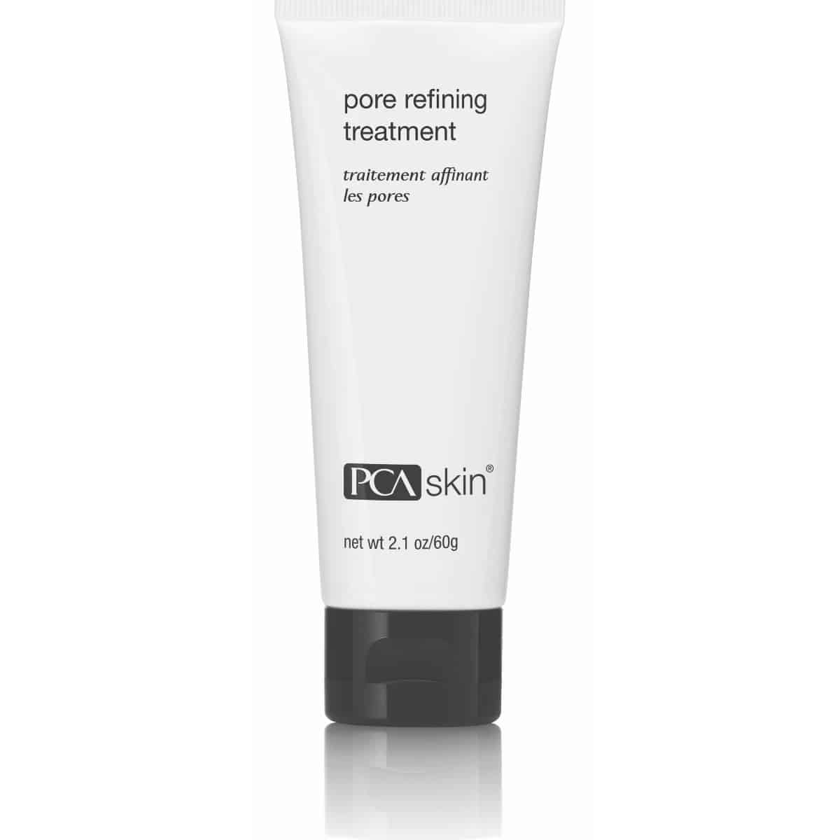 A white tube with a black flip-top cap containing Pore Refining Treatment. The text on the tube states, &quot;pore refining treatment,&quot; &quot;traitement affinant les pores&quot; and notes the net weight of 2.1 oz/60 g. This deep cleansing formula minimises pores while incorporating an exfoliating scrub for smoother skin.