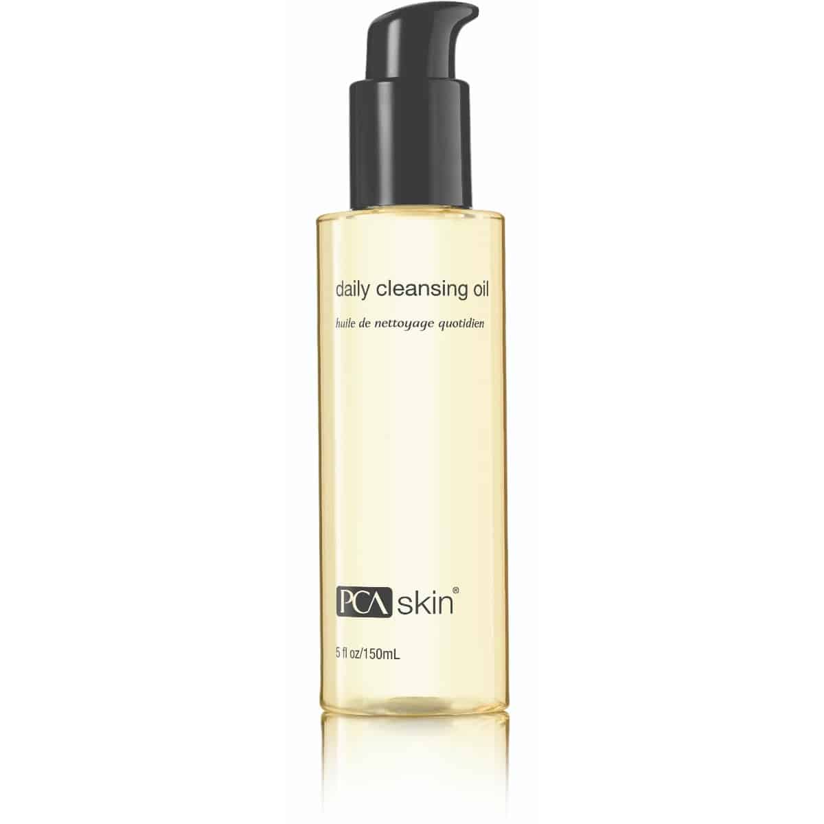 A 150mL bottle of Daily Cleansing Oil Makeup Remover with a black pump dispenser on top, filled with a light yellow liquid. The label reads &quot;daily cleansing oil&quot; in English and French, highlighting its dual function as a makeup remover. The PCA Skin logo is at the bottom.