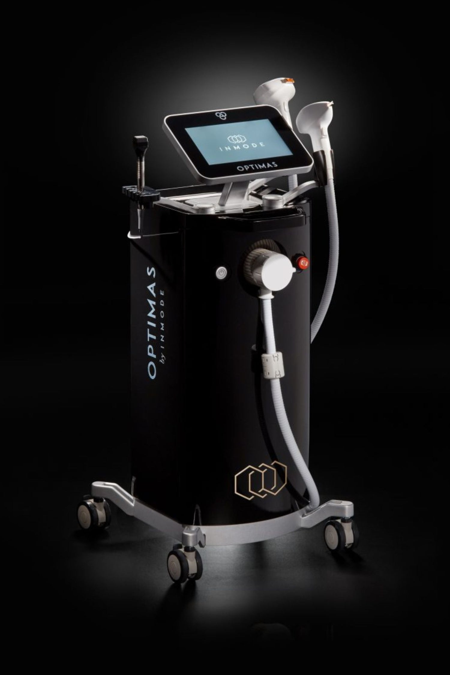 A modern medical device called Optimas, featuring a display screen and multiple hand-held attachments for non-invasive technologies, set against a dark background.