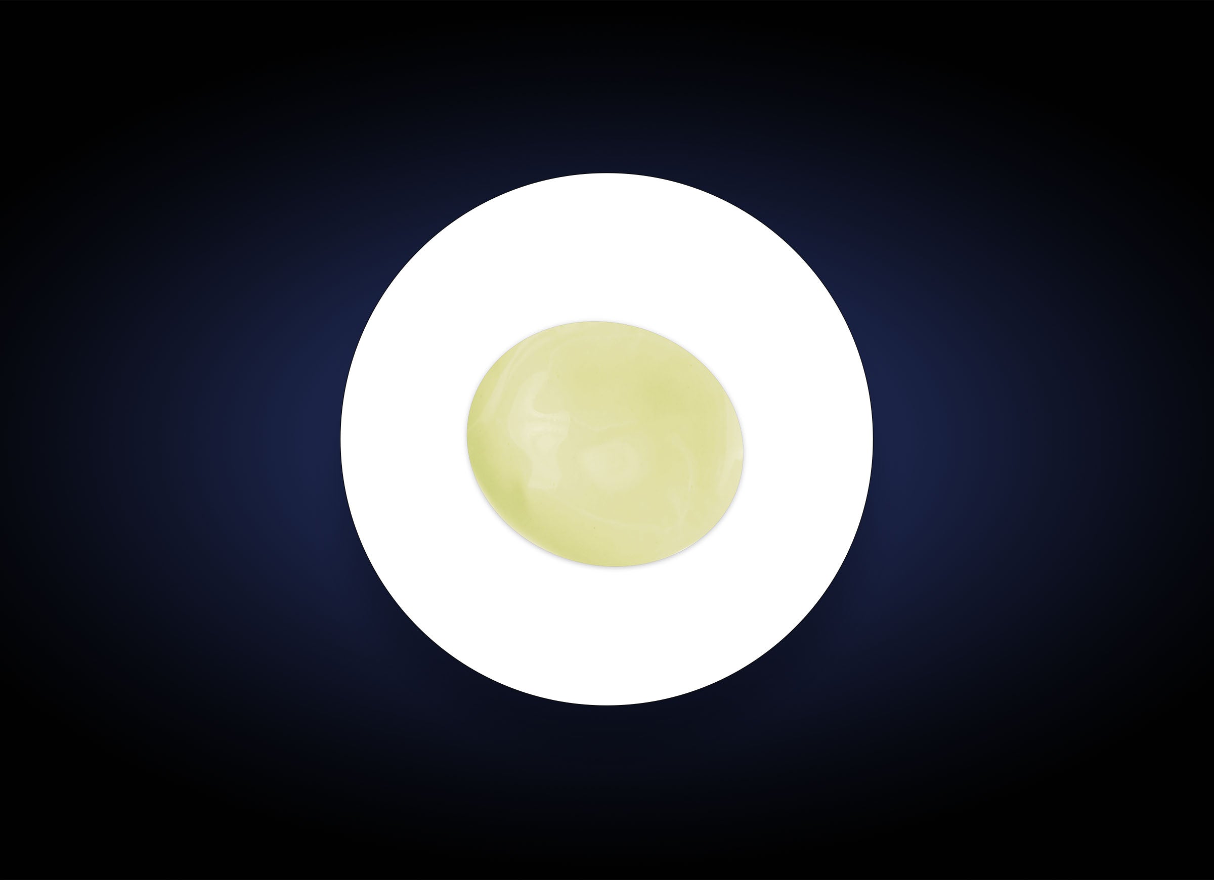 A glossy, light green sphere containing pure vitamin C sits perfectly centered on a bright white oval, set against a dark, gradient blue background. The simple, abstract composition is visually striking with contrasting colors, evoking the benefits of C&amp;E Strenght Max formulation for fine lines and wrinkles.