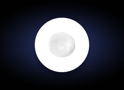 A white, circular light source with a smaller white circle in the center is set against a dark blue, almost black, gradient background, reminiscent of the soothing effect of Hydrator Plus BS SPF30 on dry skin.