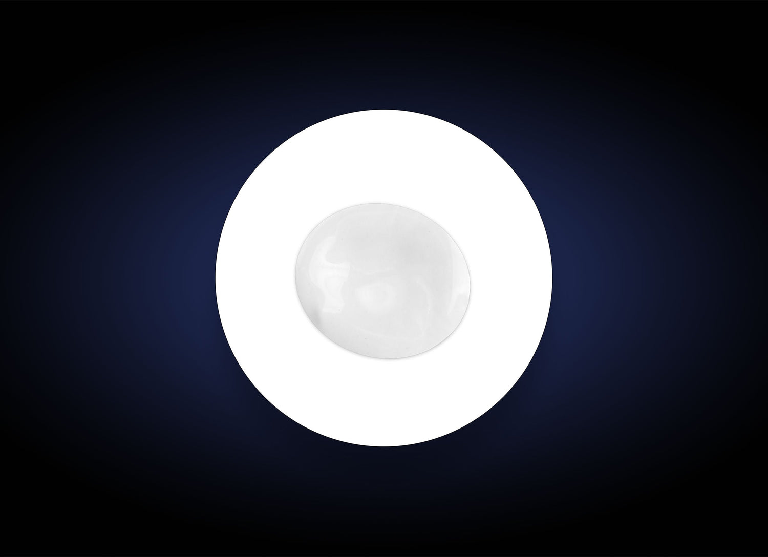 A single white round object, resembling a marble or a smooth stone, placed in the center of a white circle against a dark, gradient background. The circle and background create a striking contrast, emphasizing the simplicity and symmetry of the composition, akin to how Hyaluronic Acid Lip Booster highlights natural beauty.