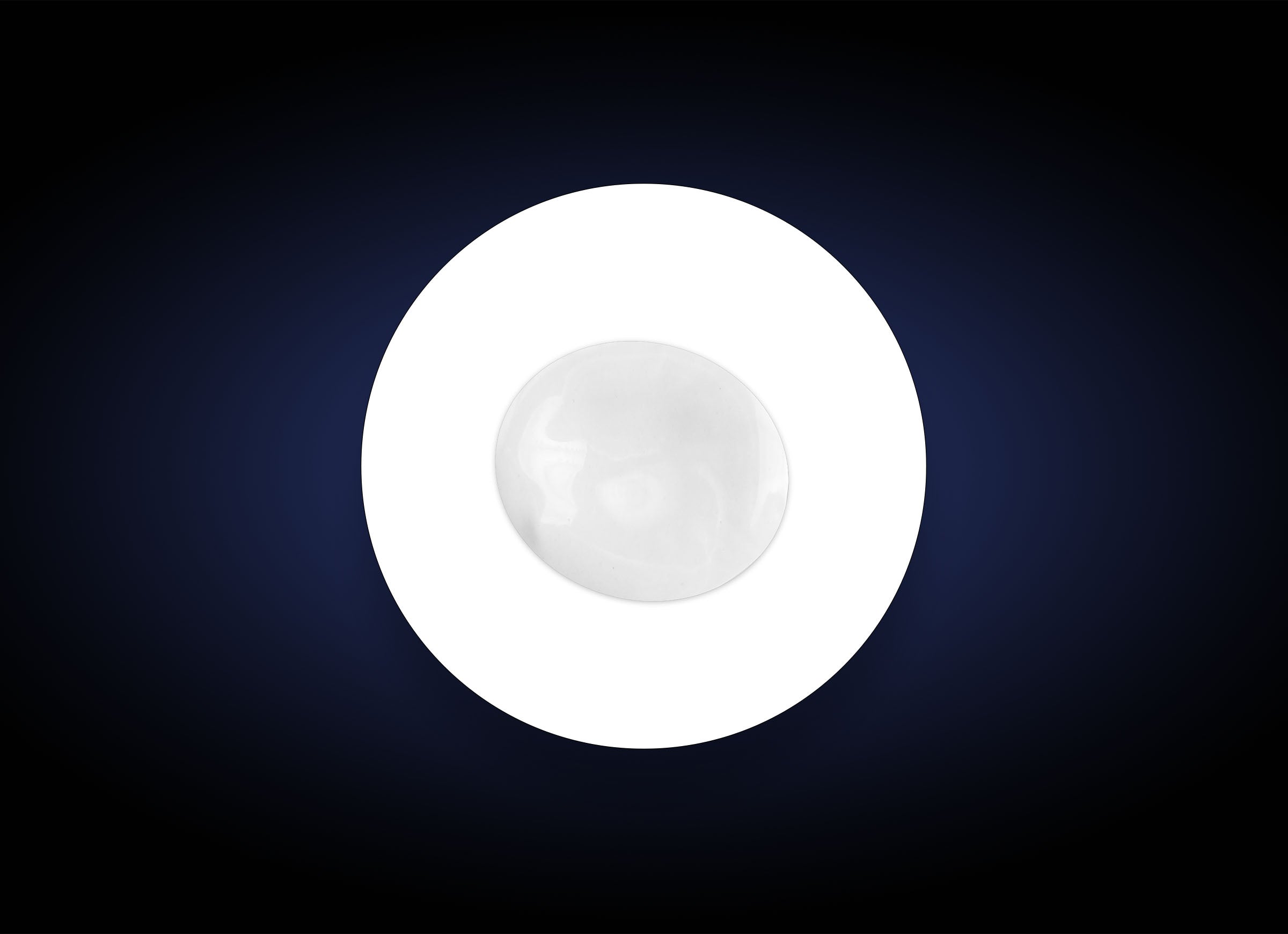 A single white round object, resembling a marble or a smooth stone, placed in the center of a white circle against a dark, gradient background. The circle and background create a striking contrast, emphasizing the simplicity and symmetry of the composition, akin to how Hyaluronic Acid Lip Booster highlights natural beauty.