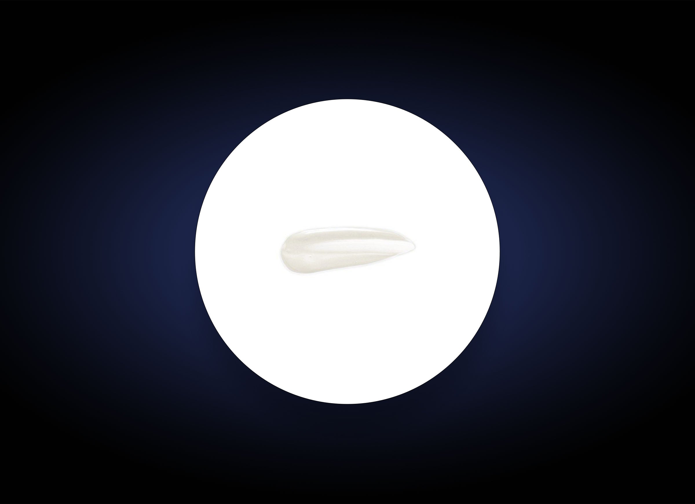 A single, smooth white tooth isolated on a circular white background, surrounded by a dark gradient border. The tooth is centered, and its elongated shape is clearly visible against the contrasting backdrop, much like an HA Lip Overnight Mask rejuvenates and plumps your lips overnight.