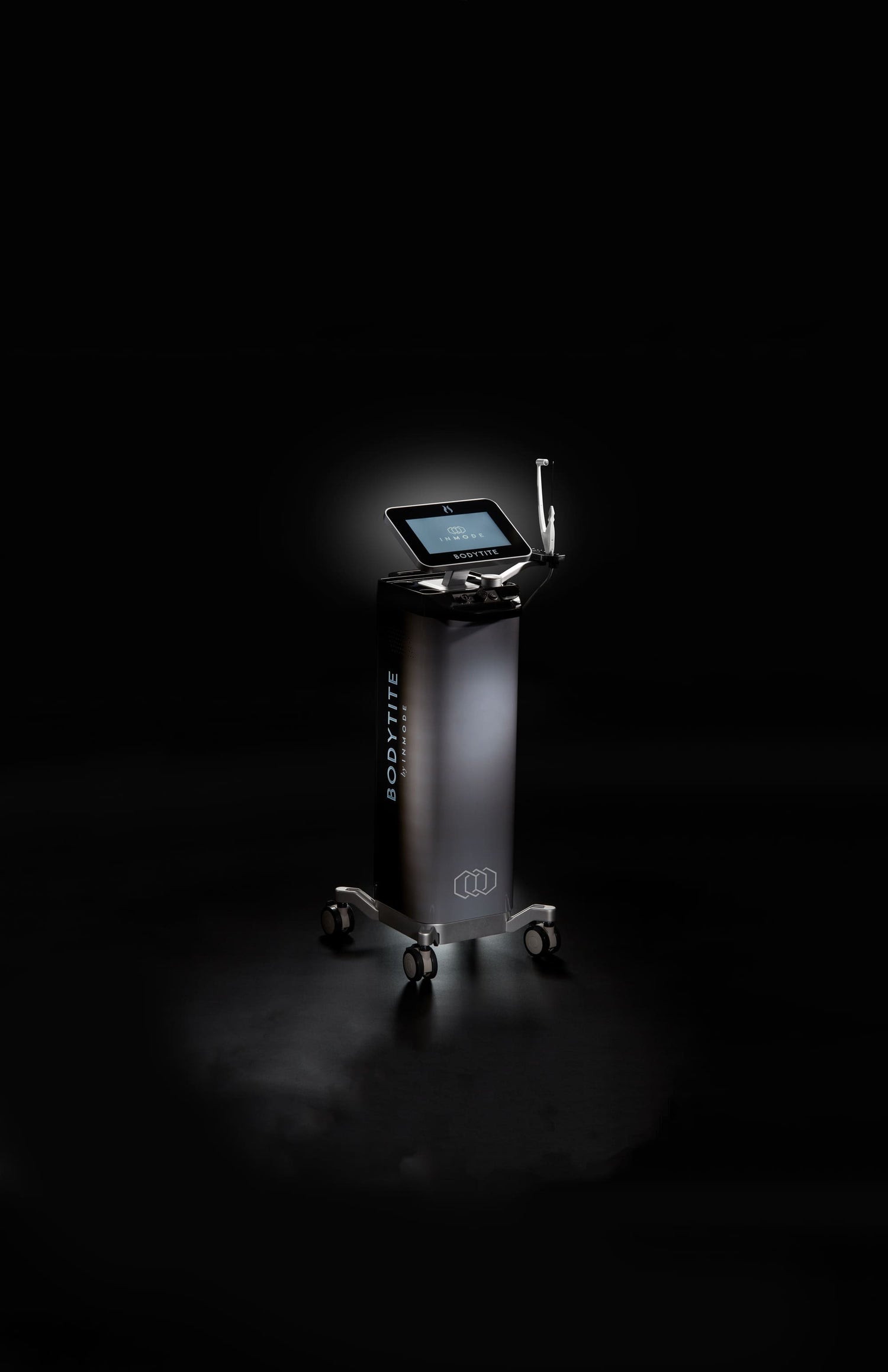 A sleek, black Bodytite machine stands on a dark background. It features a touchscreen interface on the top, with an adjustable arm extending from the side for precise body contouring using radiofrequency. The unit is mounted on wheels for mobility, and the dark setting highlights its modern design and lit display.