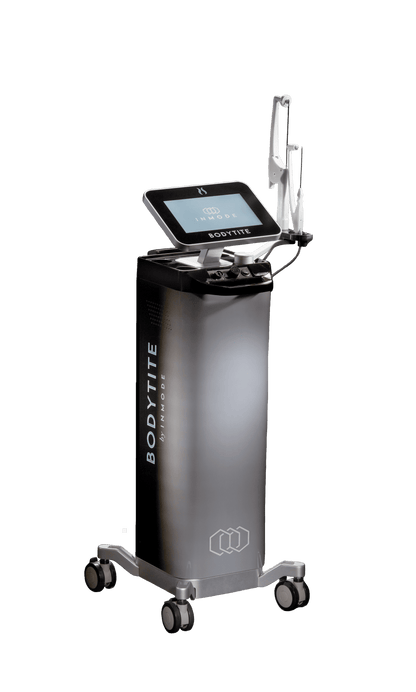 A Bodytite machine, designed for minimally invasive body contouring using radiofrequency technology, stands on a wheeled base with a sleek black and silver design. It features a touchscreen interface and a connected handpiece. The branding &quot;BodyTite by InMode&quot; is visible on its side.
