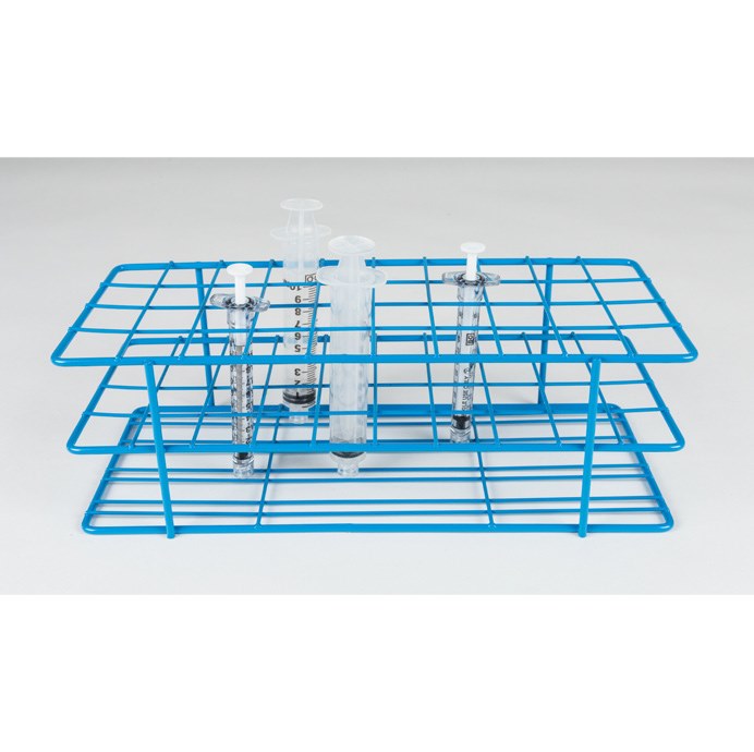 A blue wire Syringe Rack 1CC, 3CC, 5CC, 10CC, Autoclavable holds three vertical glass syringes with measured markings. Each syringe is partially filled with a clear liquid and features a white piston. The rack and syringes are set against a plain, light grey background.
