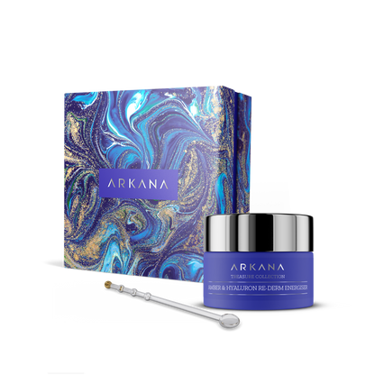 A blue and purple marbled Arkana skincare box sits beside a matching blue jar of Amber &amp; Hyaluronic Re-Derm Energiser 50 ml cream with hyaluronic acid and a silver applicator, all displayed on a white background.