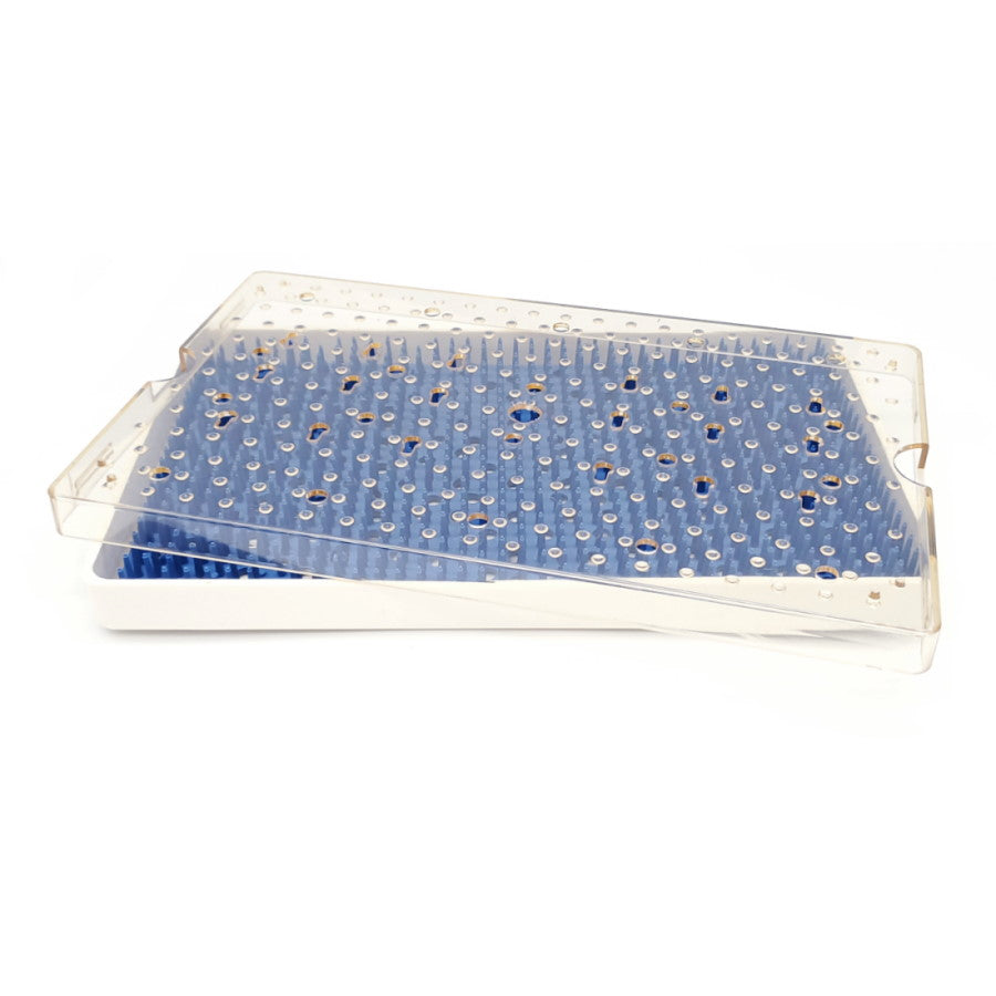 A clear plastic Sterilization Tray Single Level; Base, Lid, Mat containing blue pegs, likely used for organizing laboratory equipment such as pipette tips, is shown with its lid partially open. Perfect for those needing to sterilize instruments or transport delicate instruments safely.