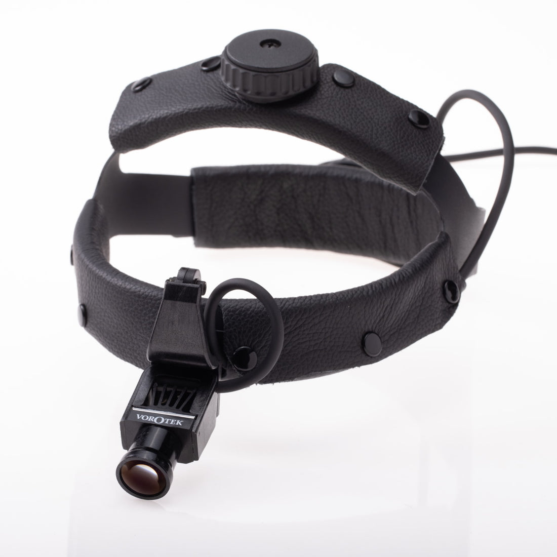 A close-up image of a black head-mounted magnifier with an adjustable strap and a small magnifying lens attached to the front. The device is designed for precision tasks, allowing users hands-free magnification. The brand name “Vorotek LED Headlight” is visible on the lens attachment, enhanced by surgical quality LED illumination.