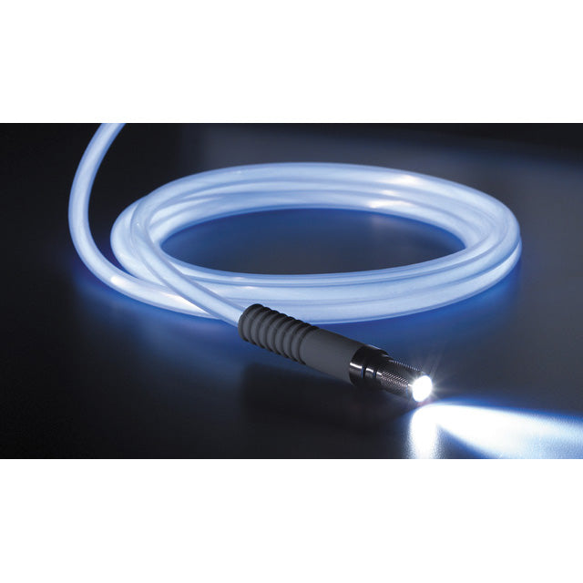 A coiled Fiber-Optic Light Cable, ACMI with a glowing lighted tip emits a beam of light. The steam-autoclavable cable, featuring a sleek black connector, is placed on a dark reflective surface, encased in a durable silicone housing.