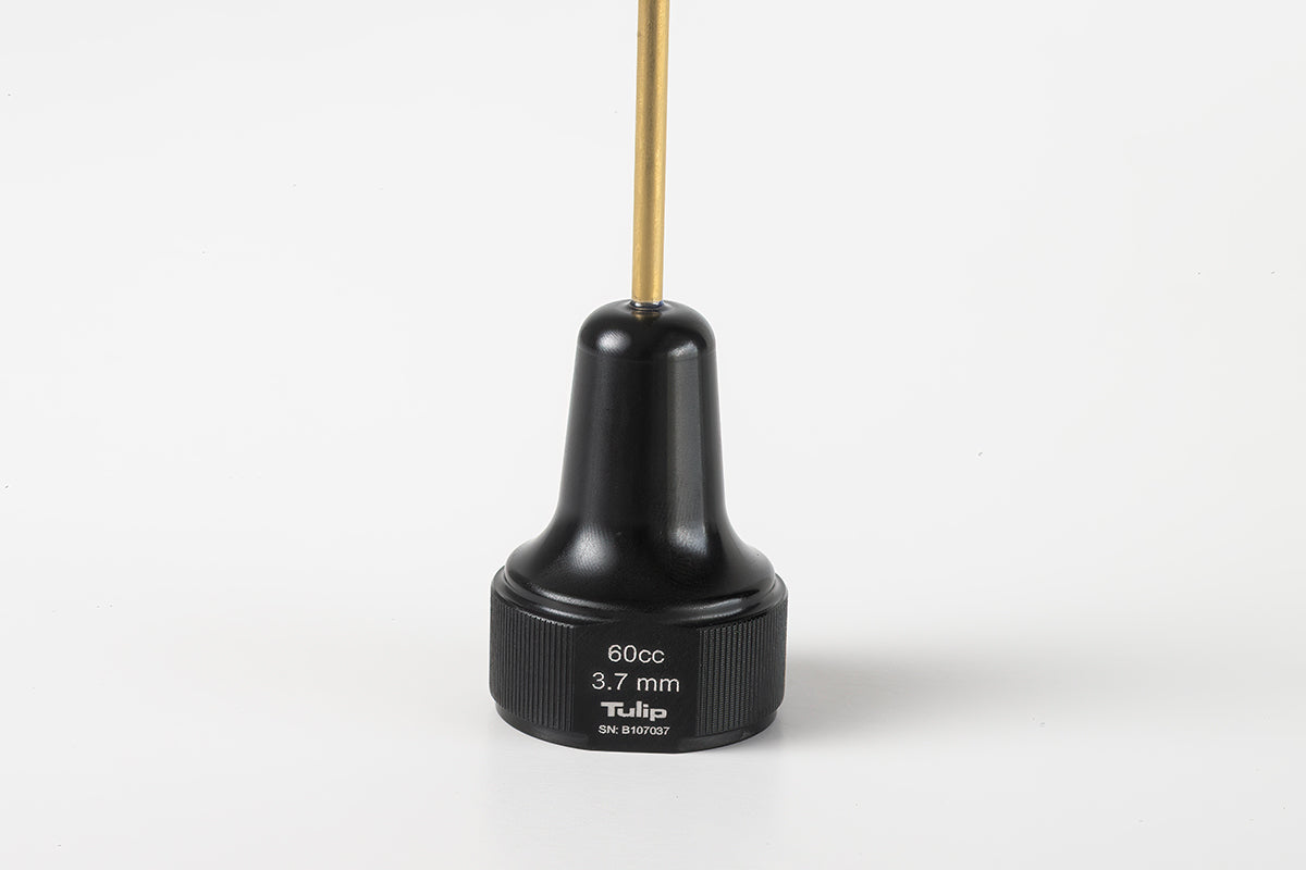 A black cylindrical medical tool labeled &quot;Tulip&quot; with a 60cc capacity and 3.7mm diameter, ideal for large volume fat transfer. This 60cc Monoject Toomey Hub Cannulas features a narrow gold-colored rod extending from the top and is placed against a plain white background.