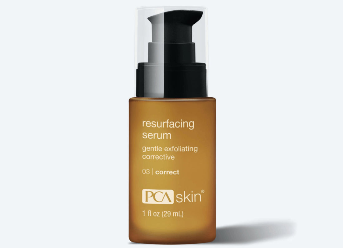 The Resurfacing Serum from PCA Skin comes in a 1 fl oz (29 mL) amber-colored bottle featuring a black pump dispenser and a clear cap. The label describes it as a &quot;gentle exfoliating corrective&quot; product containing glycolic arginine complex to promote a glowing complexion, identified as number 03 in the corrective series.