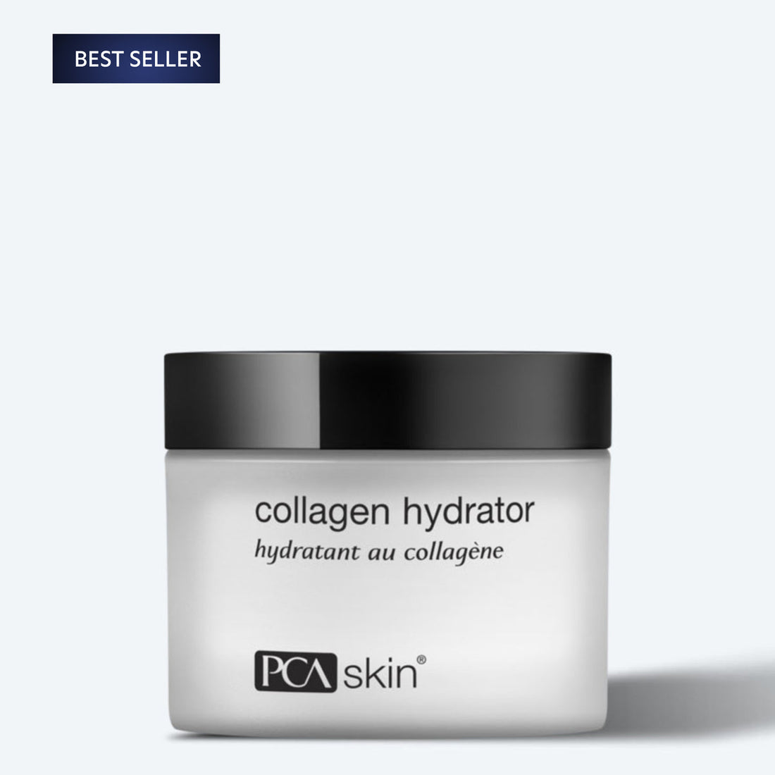 A white jar of Collagen Hydrator with a black lid is centered on a light grey background. The text on the jar reads &quot;collagen hydrator&quot; and &quot;hydratant au collagène.&quot; A blue &quot;Best Seller&quot; label is placed in the top-left corner, highlighting its role in enhancing hydration and supporting collagen production.