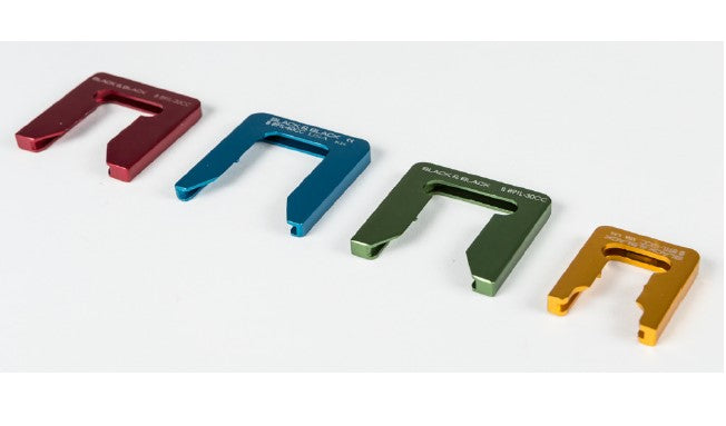 A row of four Syringe Twist Locks in different colors and sizes arranged from left to right. The locks are red, blue, green, and yellow, respectively. Each lock has text engraved at the top, detailing the size or specification.