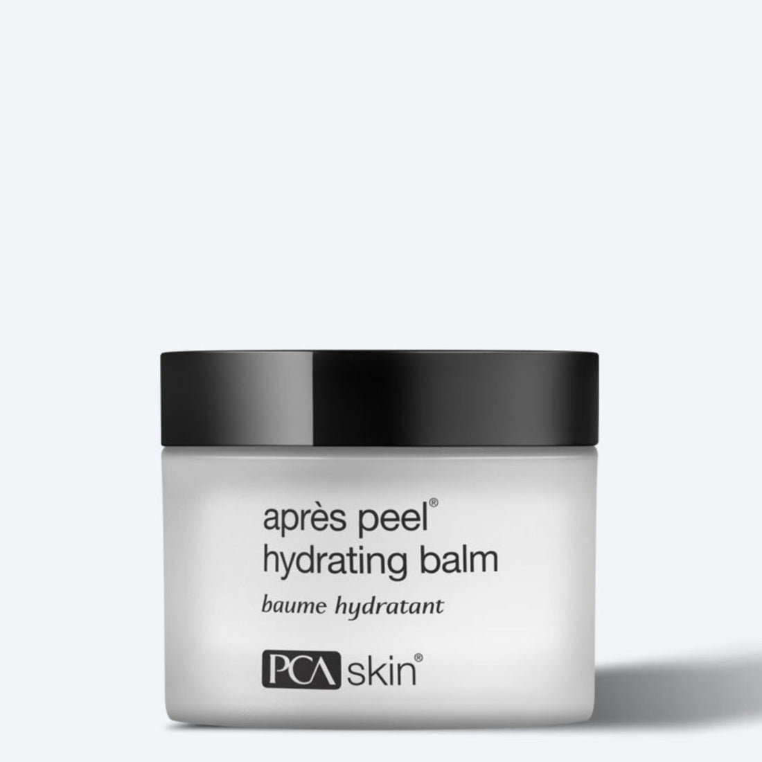 A white jar with a black lid labeled "Aprés Peel Hydrating Balm 48g" and "PCA Skin" on the front sits against a plain light background.