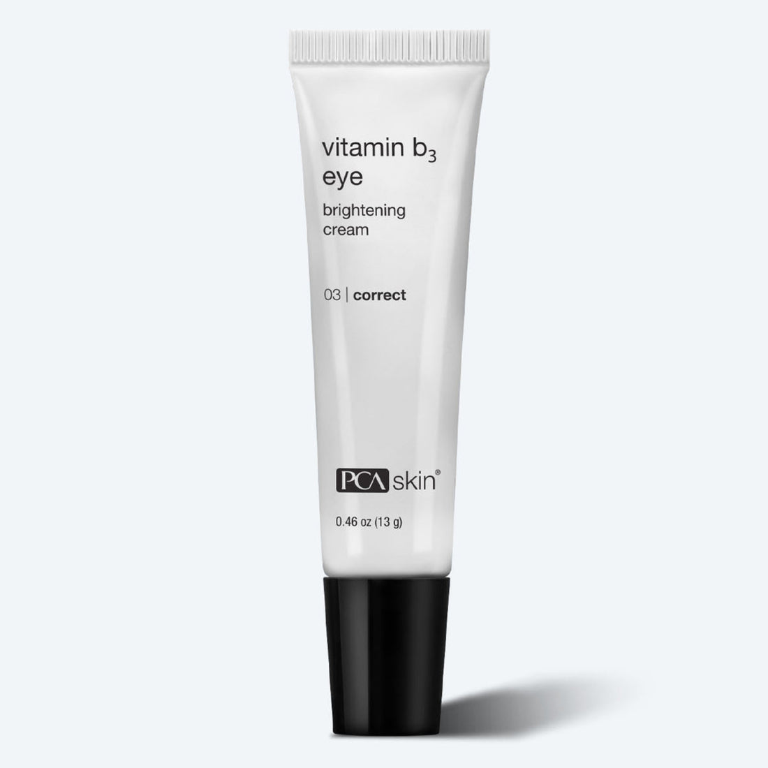 The Vitamin B3 Eye Brightening Cream, featuring a sleek black cap, is elegantly showcased against a light background in its 0.46 oz (13 g) tube to emphasize its effective formula for diminishing under-eye dark circles.